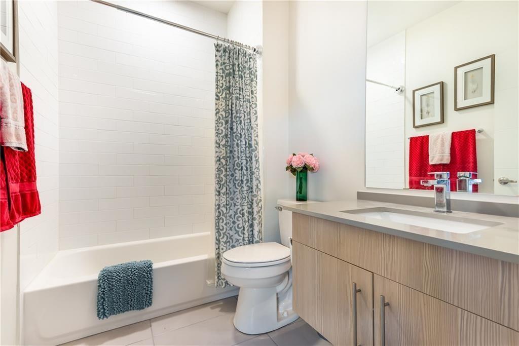 7805 Cooper Lane, Unit 601 Austin, TX 78745 - Photo 11 of 20 a bathroom with a sink a toilet and a shower
