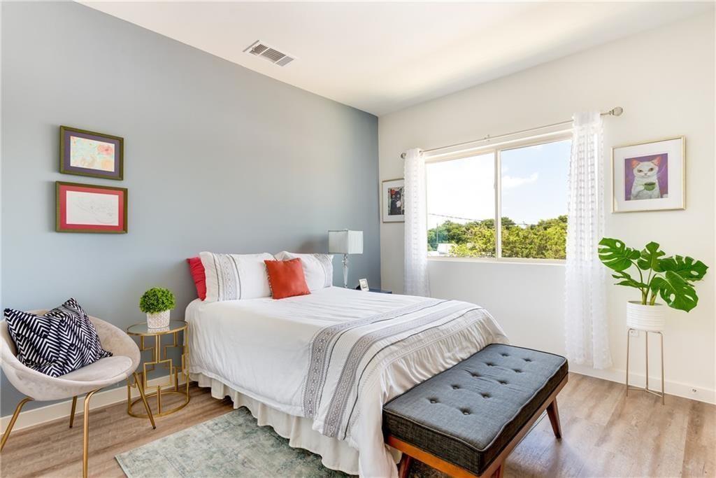 7805 Cooper Lane, Unit 601 Austin, TX 78745 - Photo 12 of 20 a bedroom with a bed and a chair