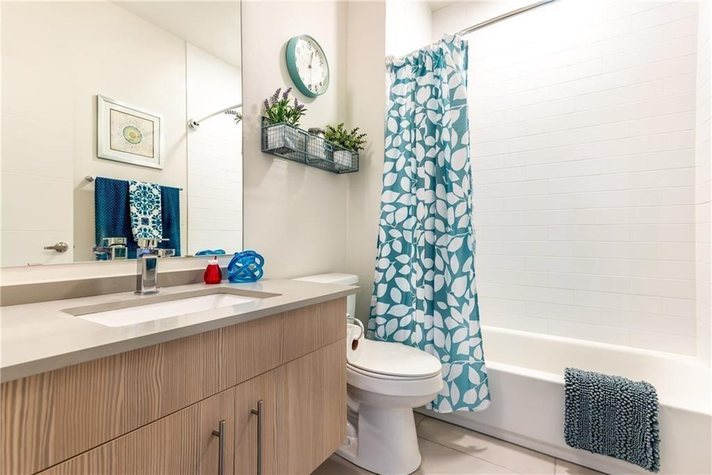 7805 Cooper Lane, Unit 601 Austin, TX 78745 - Photo 13 of 20 a bathroom with a sink a toilet and shower