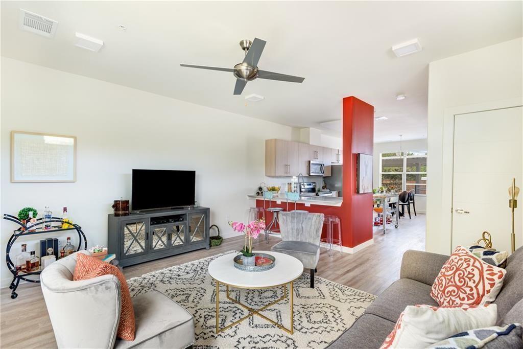 7805 Cooper Lane, Unit 601 Austin, TX 78745 - Photo 2 of 20 a living room with furniture and a flat screen tv