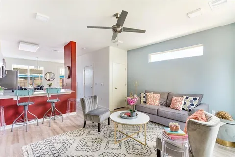 a living room with furniture and wooden floor