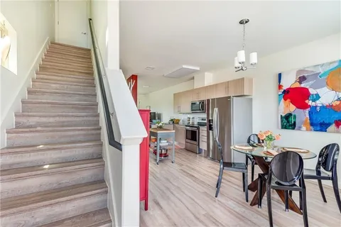 a view of entryway and dining room with stairs
