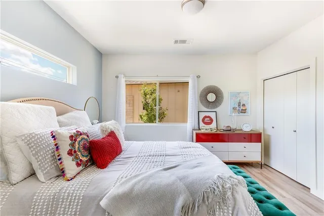 a bedroom with a bed and a window