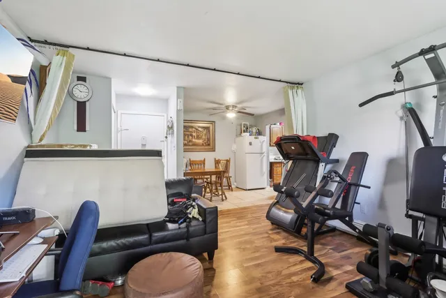 a view of a workspace with furniture and a window