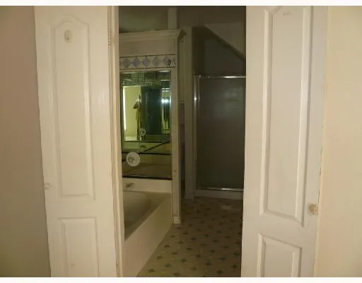 a bathroom with mirror and shower