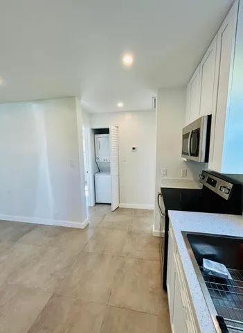 a kitchen with granite countertop a stove and a sink