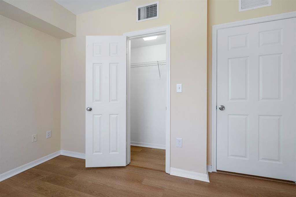 6492 Emerald Dunes Drive, Unit 208 West Palm Beach, FL 33411 - Photo 15 of 37 an empty room with wooden floor