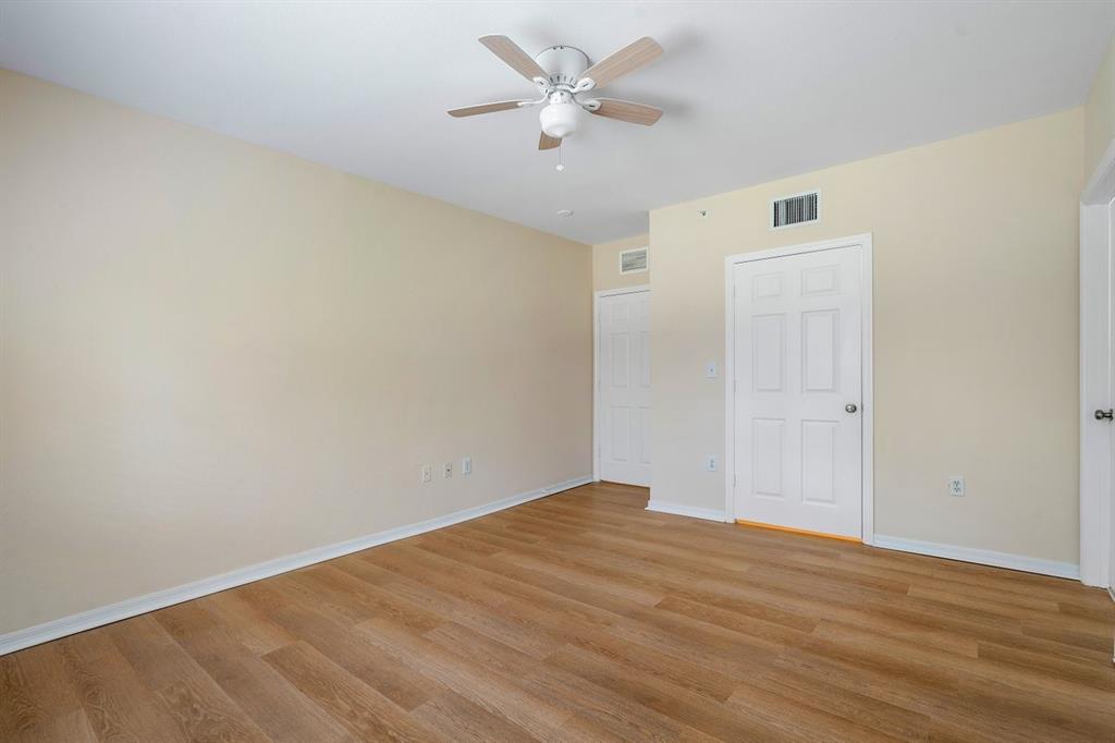 6492 Emerald Dunes Drive, Unit 208 West Palm Beach, FL 33411 - Photo 17 of 37 wooden floor in an empty room