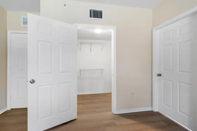 a bathroom with a granite countertop sink a toilet and a mirror