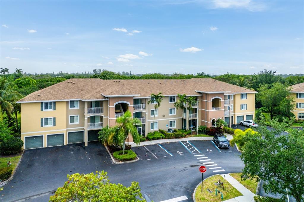 6492 Emerald Dunes Drive, Unit 208 West Palm Beach, FL 33411 - Photo 30 of 37 front view of a house with a patio
