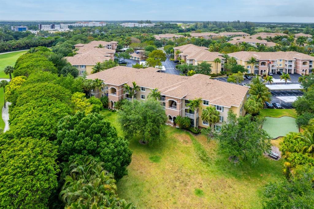 6492 Emerald Dunes Drive, Unit 208 West Palm Beach, FL 33411 - Photo 31 of 37 an aerial view of residential houses with outdoor space and river