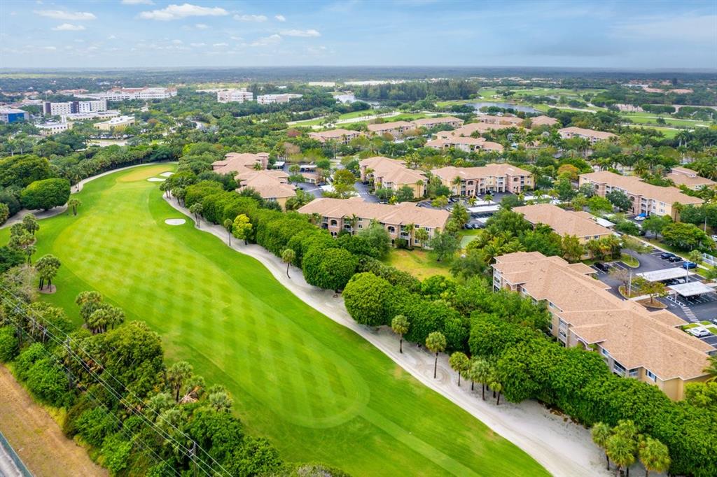 6492 Emerald Dunes Drive, Unit 208 West Palm Beach, FL 33411 - Photo 33 of 37 an aerial view of residential houses with outdoor space and river