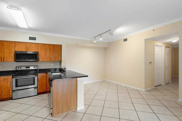 a view of a kitchen with a sink and a refrigerator