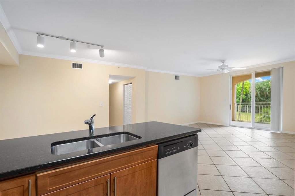 6492 Emerald Dunes Drive, Unit 208 West Palm Beach, FL 33411 - Photo 9 of 37 a kitchen with a sink and cabinets