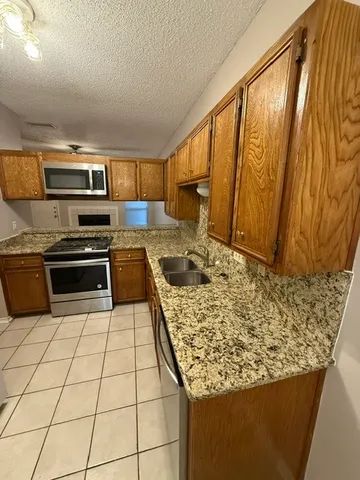 a kitchen with a stove a sink and a microwave