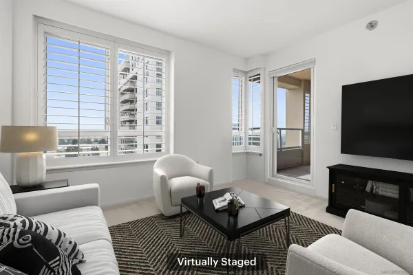 a living room with furniture a flat screen tv and a large window