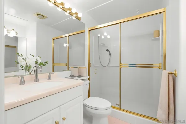 a bathroom with a shower sink and mirror