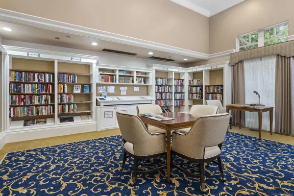 a living room with fireplace furniture and a large window