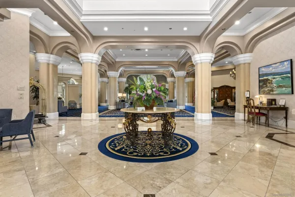 a view of a dining room with furniture a chandelier and kitchen view