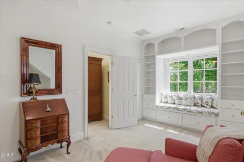 a view of a hallway and an dining rom with furniture