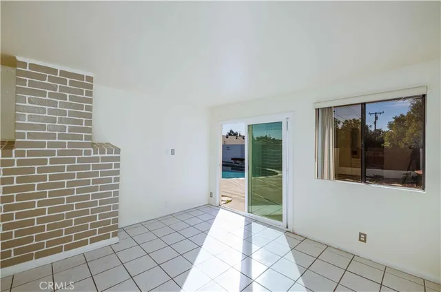 a view of a brick house with a bench in front of door