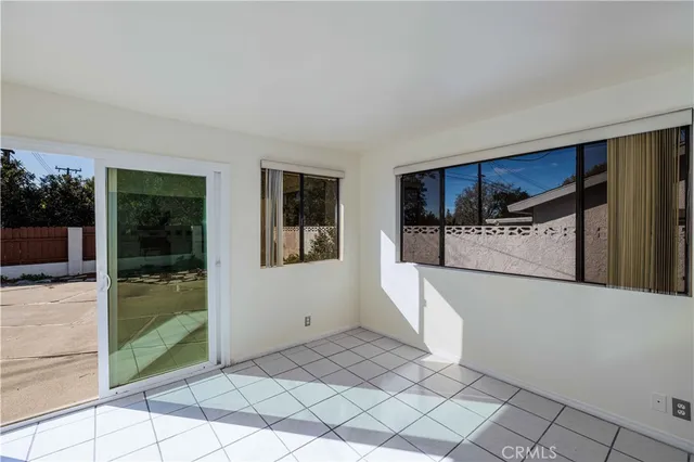 a view of a kitchen with refrigerator and sink