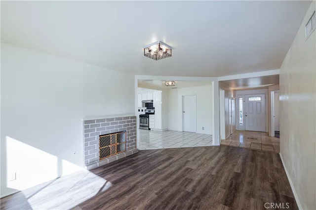 wooden floor in an empty room with a fireplace