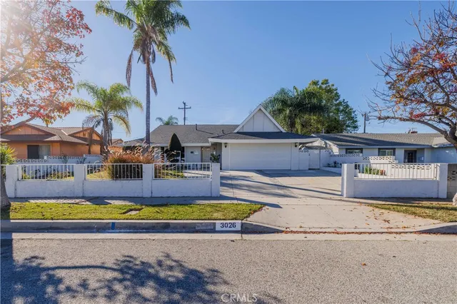 a view of a swimming pool with a yard and palm trees