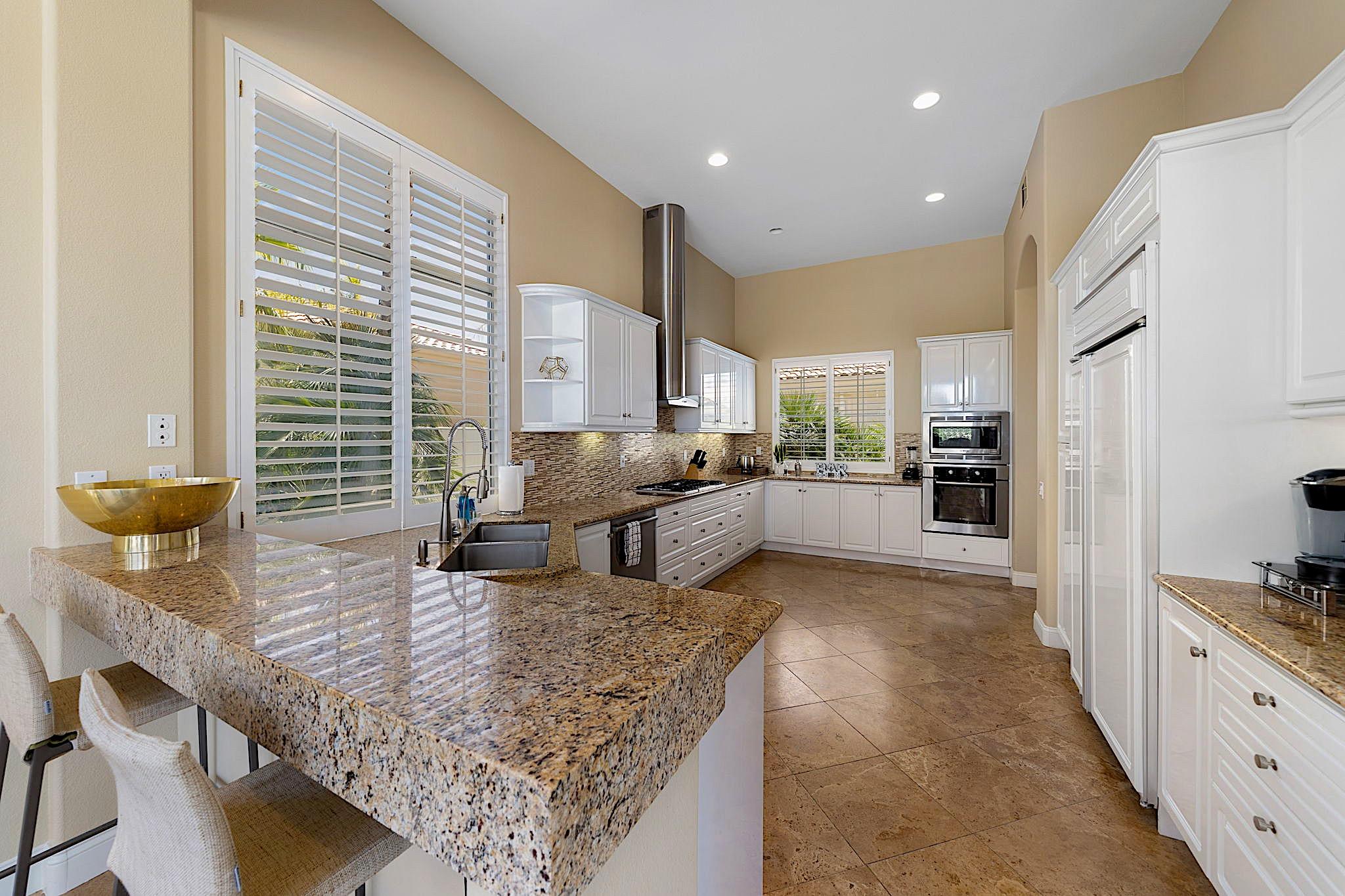 80352 Riviera La Quinta, CA 92253 - Photo 11 of 31 a kitchen with refrigerator and chairs