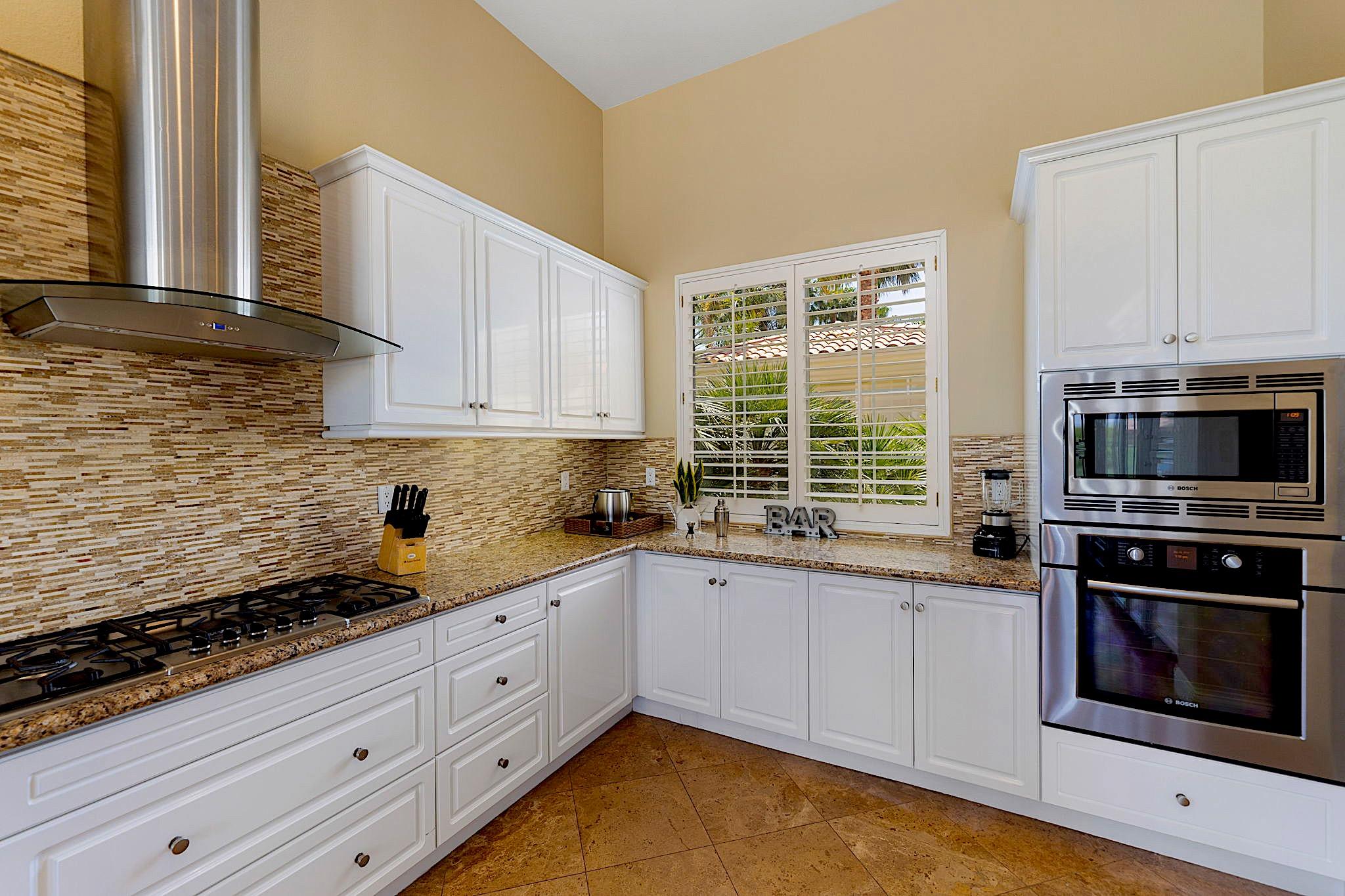 80352 Riviera La Quinta, CA 92253 - Photo 12 of 31 a kitchen with stainless steel appliances a stove a sink and a microwave