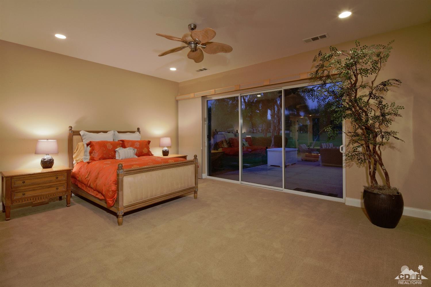 80352 Riviera La Quinta, CA 92253 - Photo 14 of 31 a bedroom with a bed and a chandelier