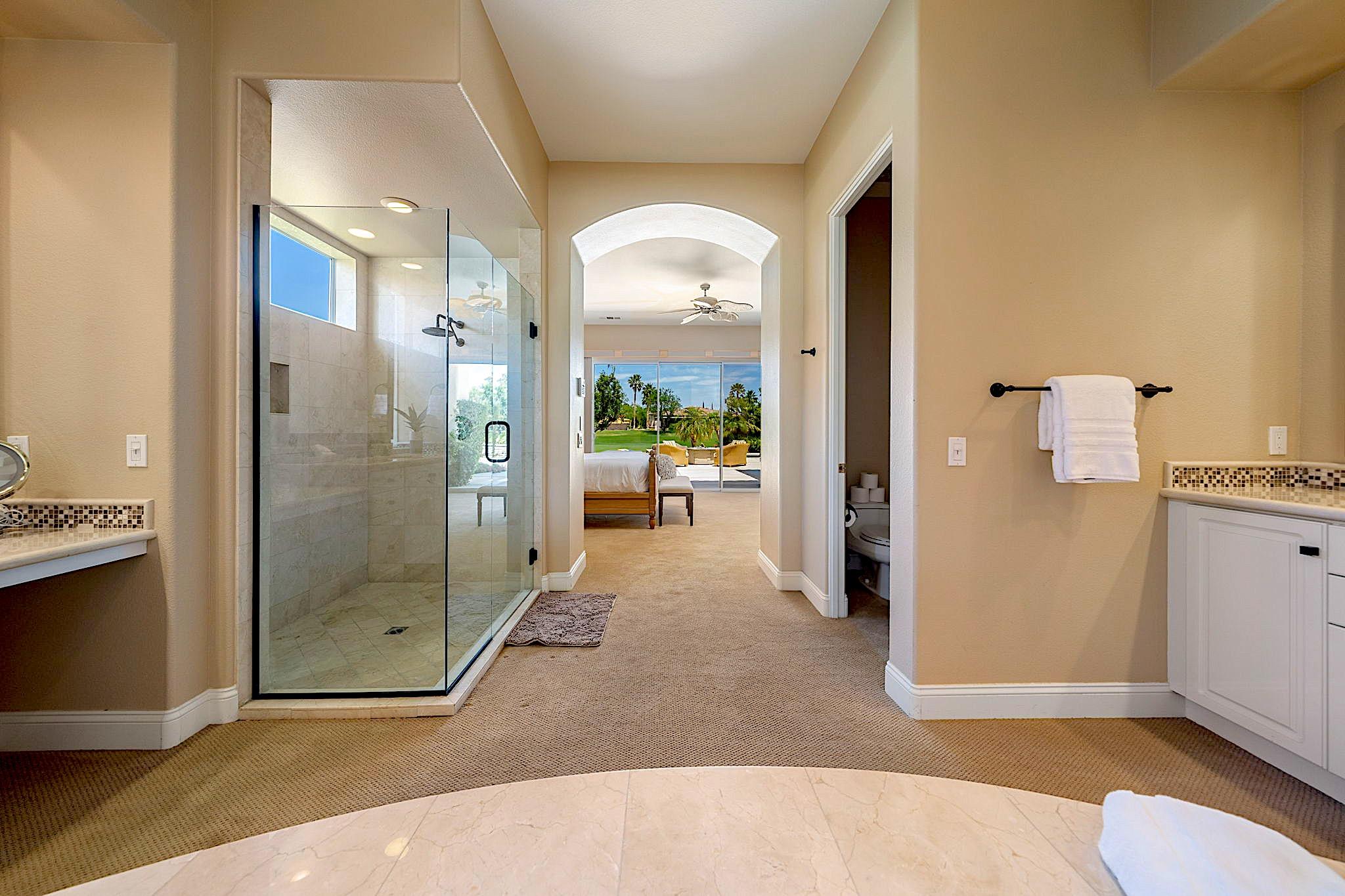 80352 Riviera La Quinta, CA 92253 - Photo 16 of 31 a view of a hallway with bathroom and glass door