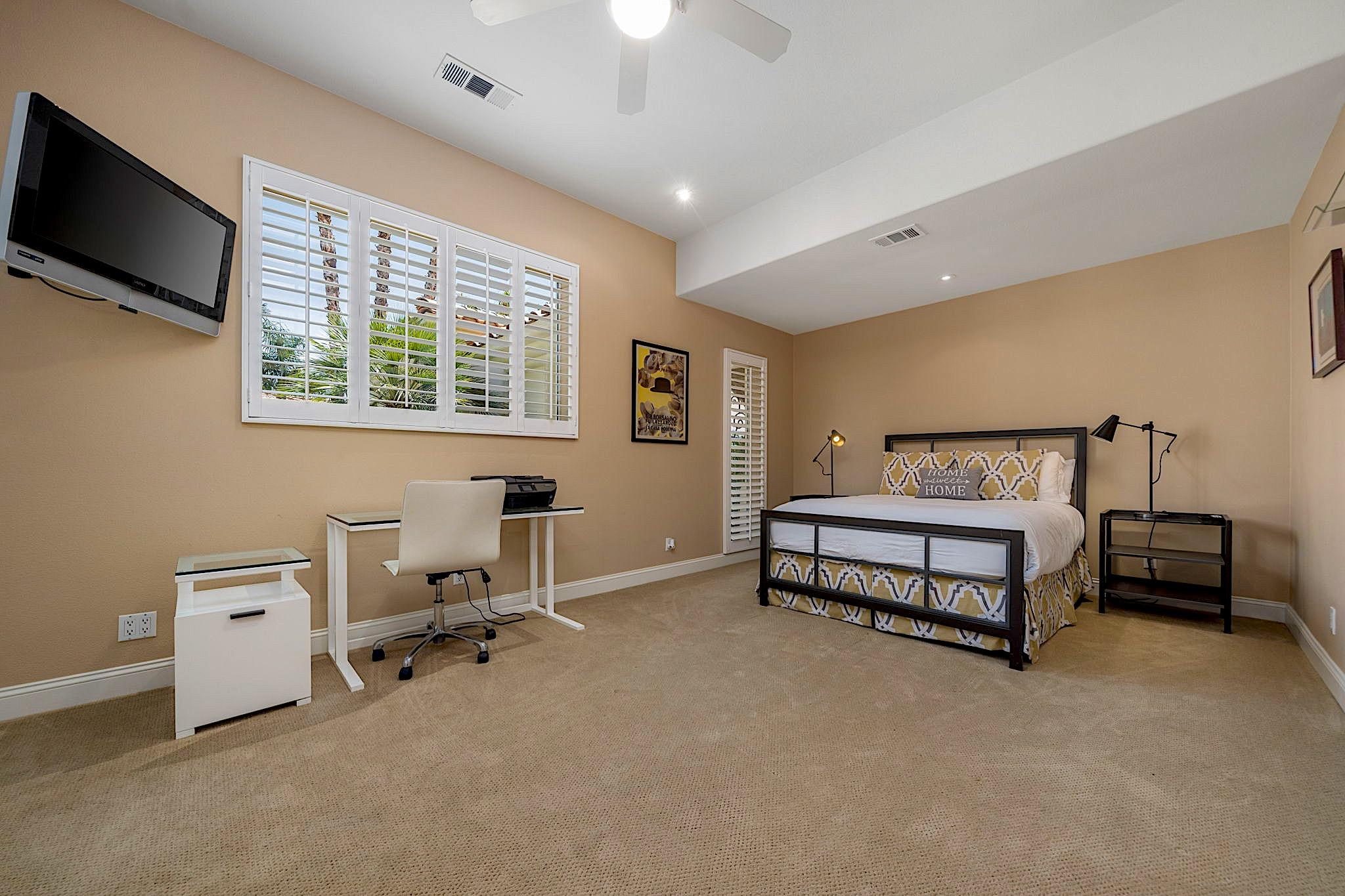 80352 Riviera La Quinta, CA 92253 - Photo 18 of 31 a spacious bedroom with a bed and a tv
