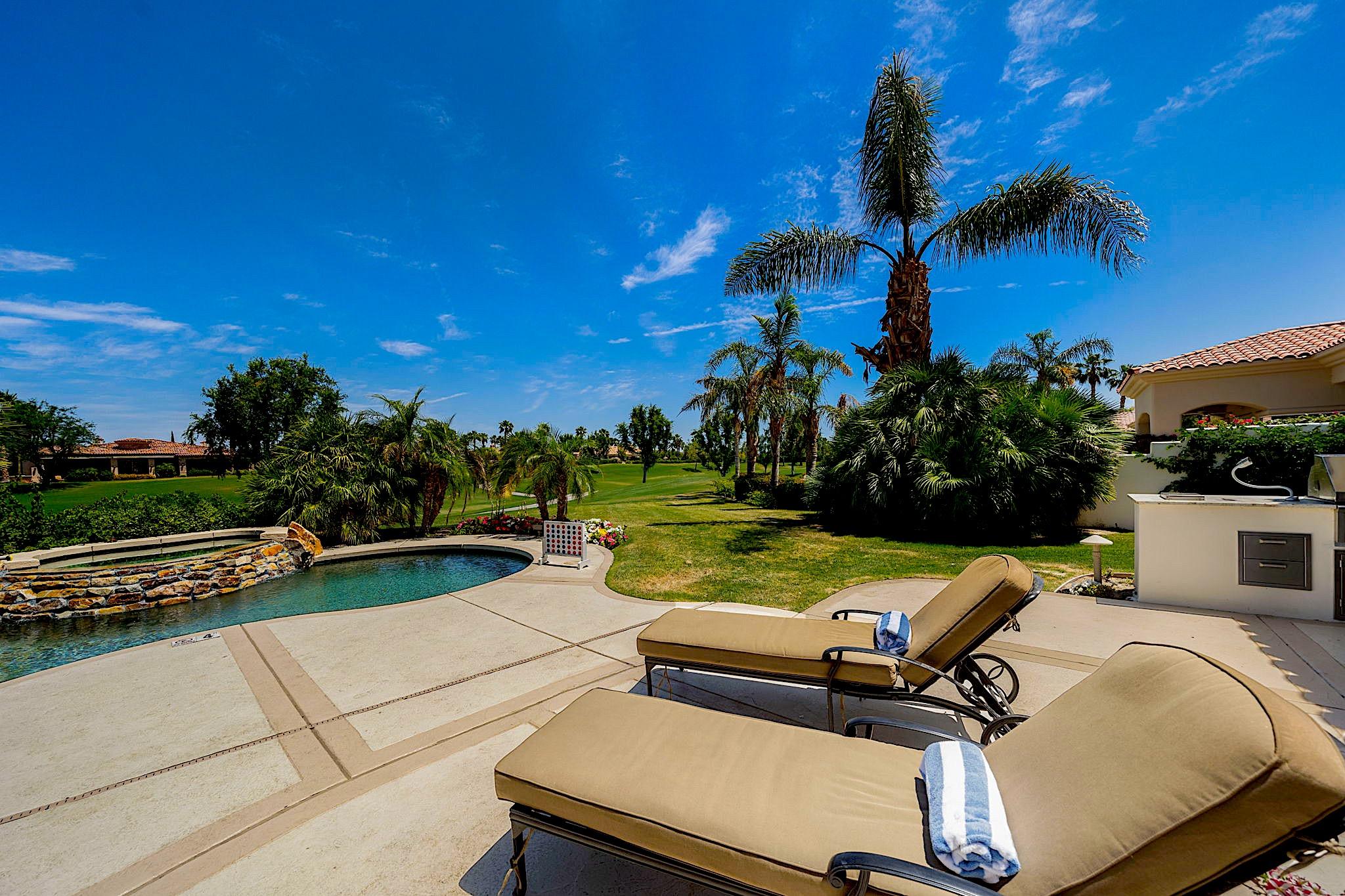 80352 Riviera La Quinta, CA 92253 - Photo 29 of 31 a view of a swimming pool with lounge chairs in patio