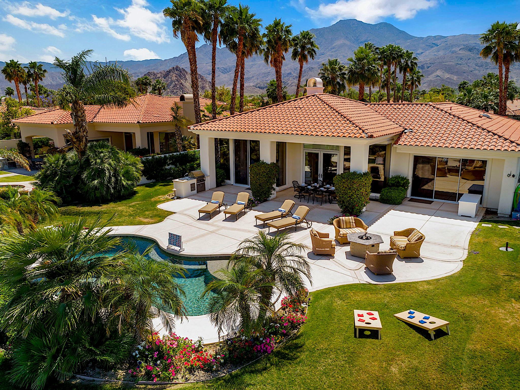 80352 Riviera La Quinta, CA 92253 - Photo 31 of 31 a view of a patio with table and chairs potted plants and palm trees