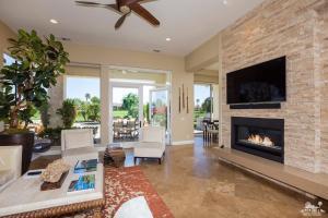 80352 Riviera La Quinta, CA 92253 - Photo 8 of 31 a living room with furniture a flat screen tv and a fireplace