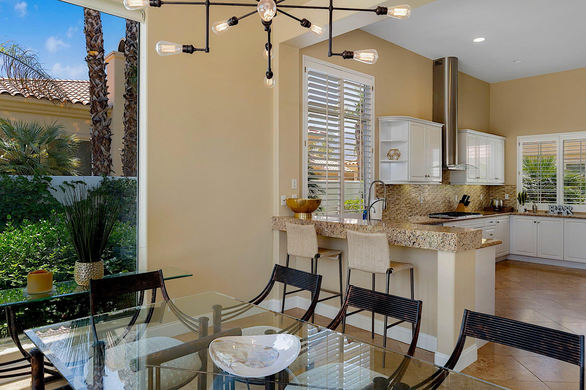 80352 Riviera La Quinta, CA 92253 - Photo 10 of 31 a kitchen with a table chairs stove and cabinets