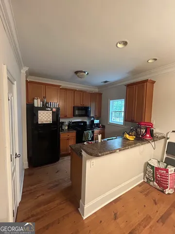 a kitchen with sink refrigerator and cabinets