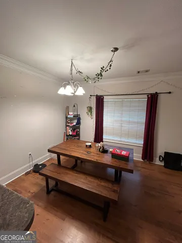 a room with wooden floor and pool table