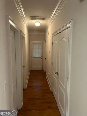a view of a hallway with wooden floor