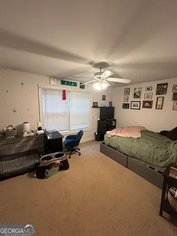 a living room with furniture gym equipment and a view of kitchen