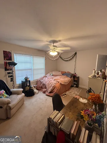 a bedroom with a bed and a couch