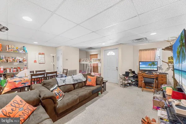 a living room with furniture a couch and dresser in it