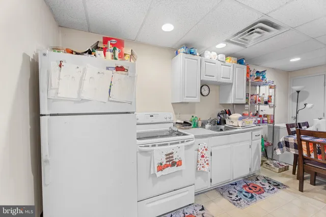 a kitchen with a refrigerator and cabinets