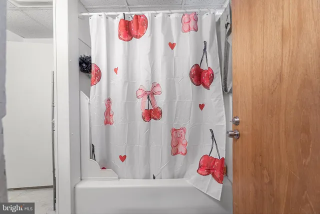 a bathroom with a bath tub and shower curtain