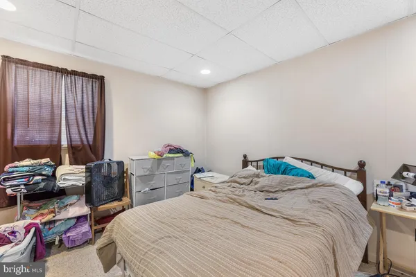 a bedroom with a bed and a couch