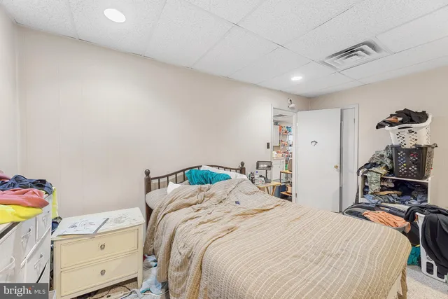 a bedroom that has a bed and a chandelier