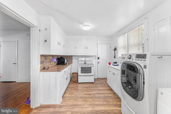a kitchen with a stove top oven sink and cabinets