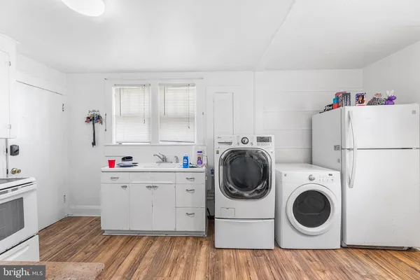 a utility room with sink dryer and washer