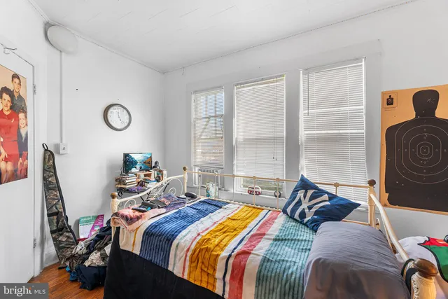 a bed sitting in a bedroom next to a window